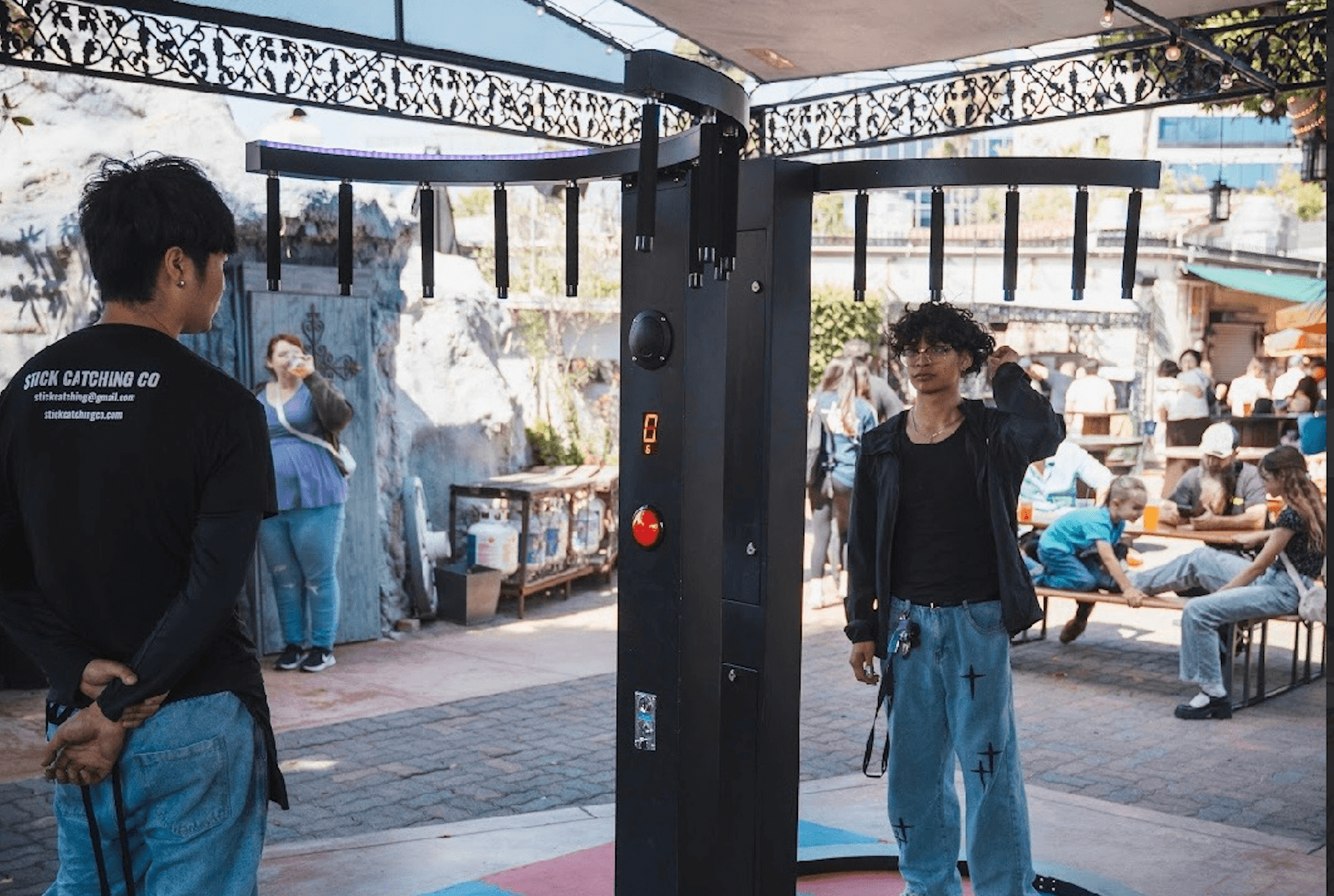 Stick Catching machine at an outdoor event with players